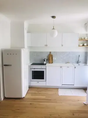 a kitchen with white appliances and a white refrigerator at Magnifique appartement Bas Gairaut aperçu mer in Nice