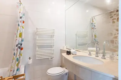a white bathroom with a toilet and a sink at VILLA CRUG HYWEL - VILLEFRANCHE-SUR-MER in Villefranche-sur-Mer