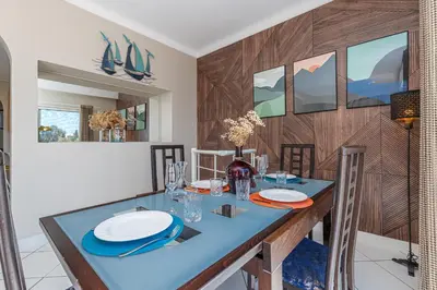 a dining room with a blue table and chairs at VILLA CRUG HYWEL - VILLEFRANCHE-SUR-MER in Villefranche-sur-Mer