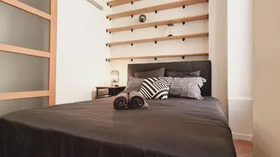 a bedroom with a bed with two slippers on it at Loft Place Massena in Nice