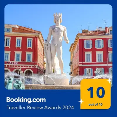 a statue in a fountain in front of two buildings at Loft Place Massena in Nice