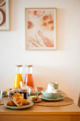 a table with two plates of pastries on it at Appartement bord de mer « La Petite Ma-Line » in Cagnes-sur-Mer