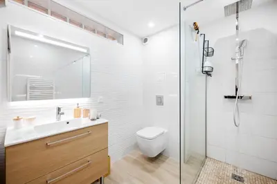 a white bathroom with a toilet and a shower at Appartement bord de mer « La Petite Ma-Line » in Cagnes-sur-Mer