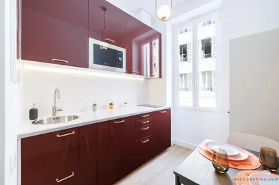 a kitchen with dark brown cabinets and a sink at Nice Renting - FRANCE - Luxury Suite Palace Love Jacuzzi - Few meters from Sea in Nice