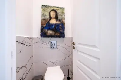 a bathroom with a painting on the wall next to a toilet at Nice Renting - FRANCE - Luxury Suite Palace Love Jacuzzi - Few meters from Sea in Nice