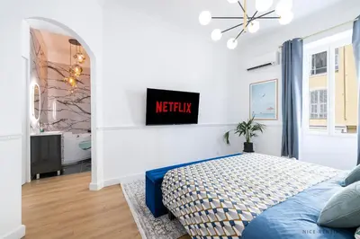 a bedroom with a bed and a tv on a wall at Nice Renting - FRANCE - Luxury Suite Palace Love Jacuzzi - Few meters from Sea in Nice