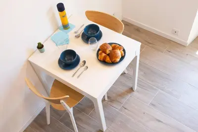 a white table with a plate of bread on it at #2 Central Studio top floor AC & Balcony in Nice