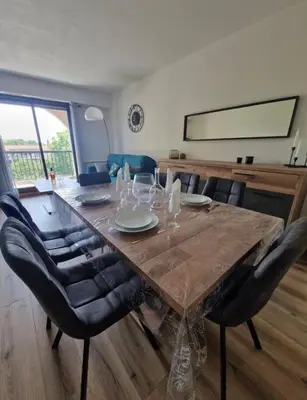 a living room with a long table and chairs at Cagnes sur Mer-Spacieux 2 pièces in Cagnes-sur-Mer