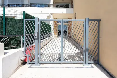 a metal gate with a stairway in a building at #43 Design Studio Terrace AC Wifi Sea View 1min Beach in Nice