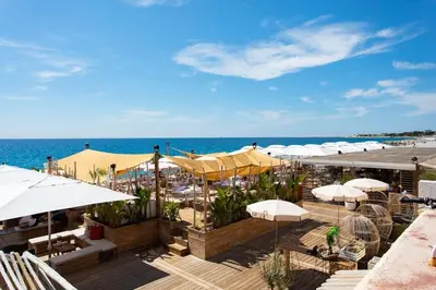 a view of a beach with umbrellas and the ocean at #43 Design Studio Terrace AC Wifi Sea View 1min Beach in Nice