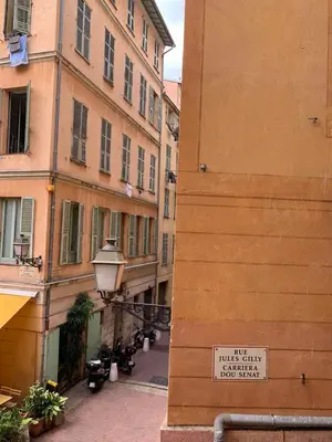an alley between two buildings with a sign on it at Apartment 33 on The Old Historic Senate Square in Nice