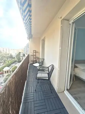 a balcony with three chairs on a building at F4 avec vue mer / Flat with sea view 3 bedrooms in Nice