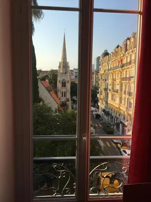 an open window with a view of a city at Magnifique studio carré d’or in Nice