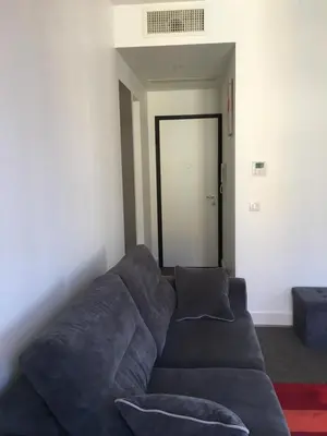 a blue couch in a living room with a door at Magnifique studio carré d’or in Nice