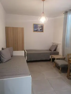 a room with a bed and a couch and a table at maison de papa in Nice