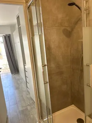 a shower with a glass door in a bathroom at Chambre promenade des anglais in Nice