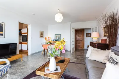 a living room with a couch and a table at LE CALIFORNIA 3 AP4366 By Riviera Holiday Homes in Villefranche-sur-Mer
