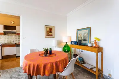 a dining room with a table and a kitchen at LE CALIFORNIA 3 AP4366 By Riviera Holiday Homes in Villefranche-sur-Mer