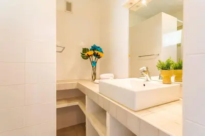 a white bathroom with a sink and a mirror at LE CALIFORNIA 3 AP4366 By Riviera Holiday Homes in Villefranche-sur-Mer