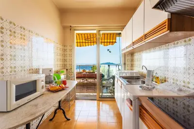 a kitchen with a counter top with a microwave at LE CALIFORNIA 3 AP4366 By Riviera Holiday Homes in Villefranche-sur-Mer
