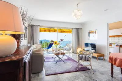 a living room with a couch and a table at LE CALIFORNIA 3 AP4366 By Riviera Holiday Homes in Villefranche-sur-Mer