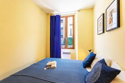 a bedroom with a blue bed and a window at LE ST FRANCOIS AP4368 By Riviera Holiday Homes in Nice