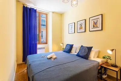 a bedroom with a blue bed with two stuffed animals on it at LE ST FRANCOIS AP4368 By Riviera Holiday Homes in Nice