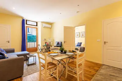 a living room with a table and a couch at LE ST FRANCOIS AP4368 By Riviera Holiday Homes in Nice