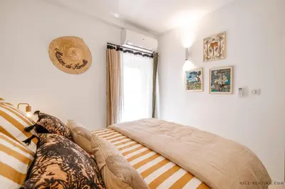a bedroom with a bed and a window at Nice Renting - NEUVE - Luxury Triplex Old Town Massena Garibaldi - 4 BedRoom - AC in Nice