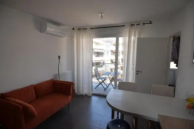 a living room with a couch and a table at VILLA SMOLETT - Appartement Cosy au cœur du quartier du port in Nice