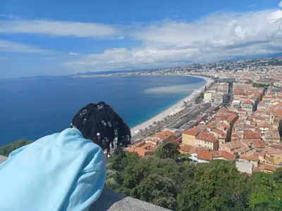 a person sitting on top of a tower looking at the water at Le Grand Sud in Nice