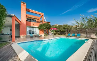 a swimming pool in front of a house at Nice Home In Saint-Laurent-Du-Var in Saint-Laurent-du-Var