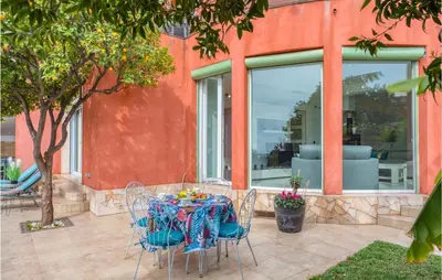 a table and chairs sitting on a patio at Nice Home In Saint-Laurent-Du-Var in Saint-Laurent-du-Var