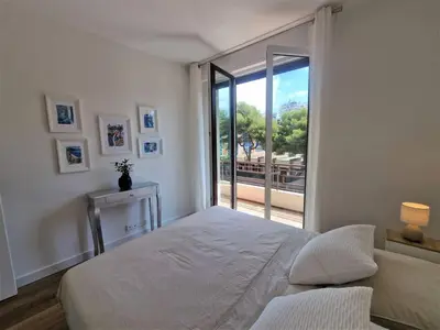a bedroom with a bed and a large window at The Chic Libération in Nice