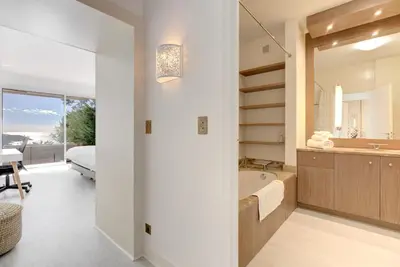a bathroom with a tub and a bedroom with a bed at Giant Terrace on a stunning View in Villefranche-sur-Mer