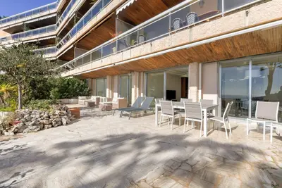 a patio with chairs and a table on a building at Giant Terrace on a stunning View in Villefranche-sur-Mer