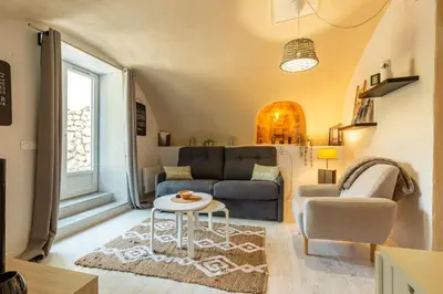 a living room with a couch and a table at Domaine luna estella in Tourrette-Levens