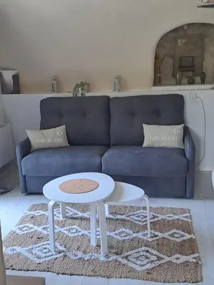 a living room with a blue couch and a table at Domaine luna estella in Tourrette-Levens