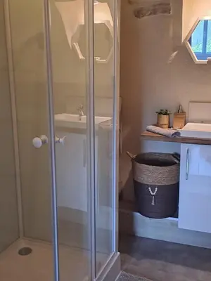 a glass shower in a bathroom with a sink at Domaine luna estella in Tourrette-Levens