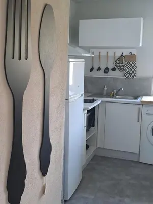 a fork hanging on a wall in a kitchen at Domaine luna estella in Tourrette-Levens