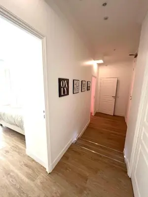 an empty room with a bed and a hallway at Large Haussmanian appartment in the heart of Nice in Nice