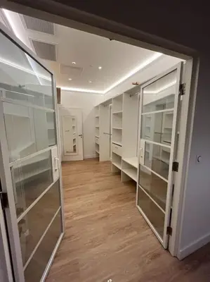 a walk in closet with glass shelves and a hallway at Large Haussmanian appartment in the heart of Nice in Nice