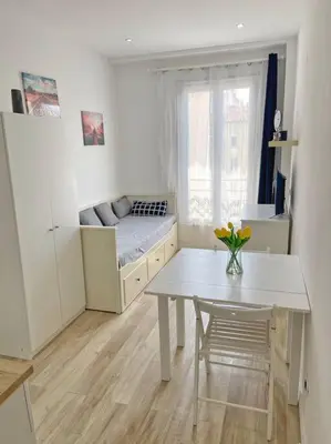 a living room with a table and a couch at Studio au coeur de Nice in Nice