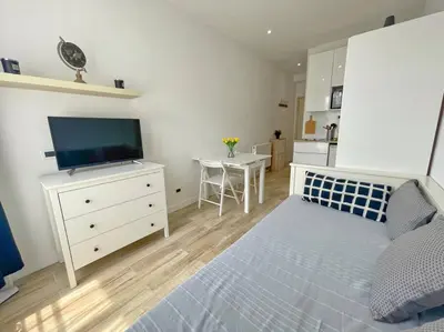 a bedroom with a bed and a dresser with a television at Studio au coeur de Nice in Nice