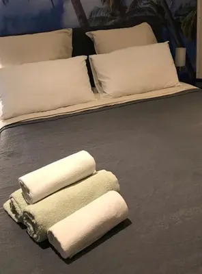 a bed with three white towels on it at Summer Beach Studio, 4 persons, mobile AC, Old Town in Nice