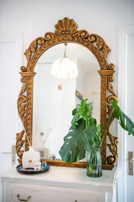 an ornate mirror on top of a dresser at Résidence méditerranée - Beachfront - Sun and Seaview - Pool - Private Parking in Cagnes-sur-Mer