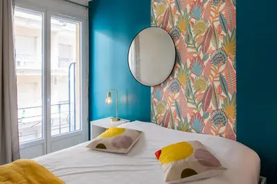 a bedroom with a large bed with a mirror at #10 2Pièces Fricéro 3min to the beach/Balcon & AC in Nice