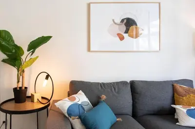 a living room with a gray couch and a table at #10 2Pièces Fricéro 3min to the beach/Balcon & AC in Nice