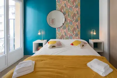 a bedroom with a large bed with blue walls at #10 2Pièces Fricéro 3min to the beach/Balcon & AC in Nice