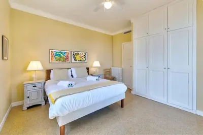 a bedroom with a large white bed and two lamps at Villa Francesca Beautiful villa with sea view and swimming pool! in Villefranche-sur-Mer